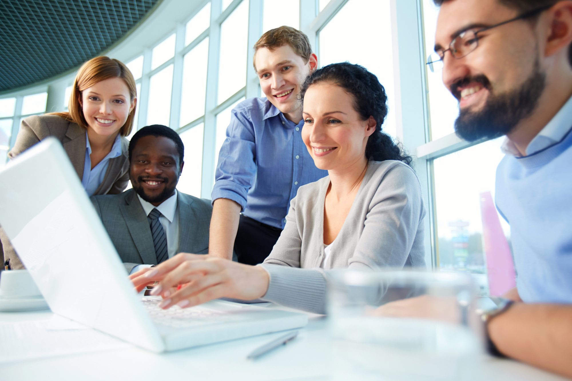 smiling-executives-having-meeting-around-table